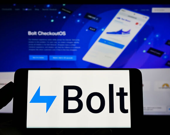 Closeup shot of a smartphone with Bolt logo kept in front of a Bolt website.