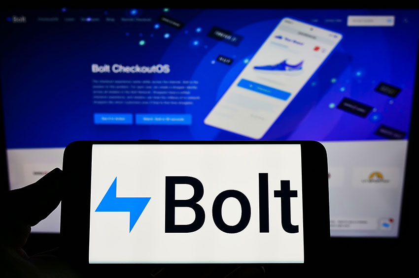 Closeup shot of a smartphone with Bolt logo kept in front of a Bolt website.