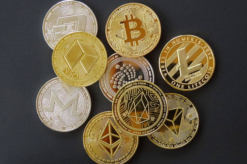 Multiple coins with digital crypto symbols