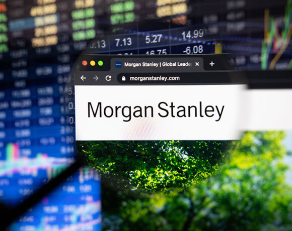 Morgan Stanley website with a blurry background featuring stock market and trees.