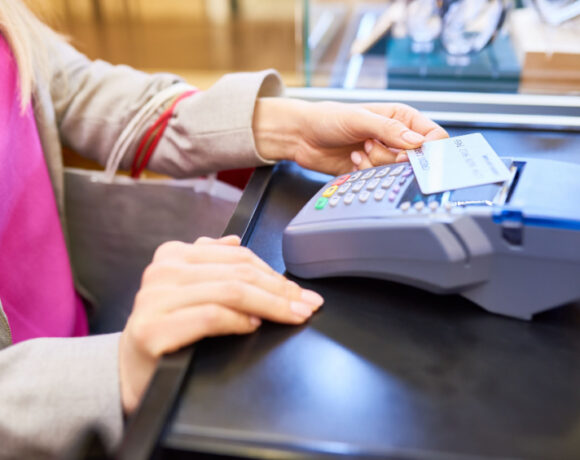 Woman tapping a card for payment.