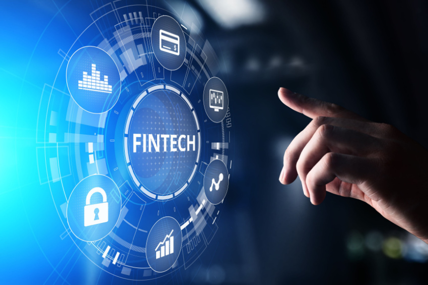 A hand is touching a virtual screen displaying Fintech Financial technology concept.