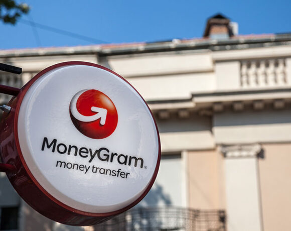 Moneygram money transfer display in front of a building.