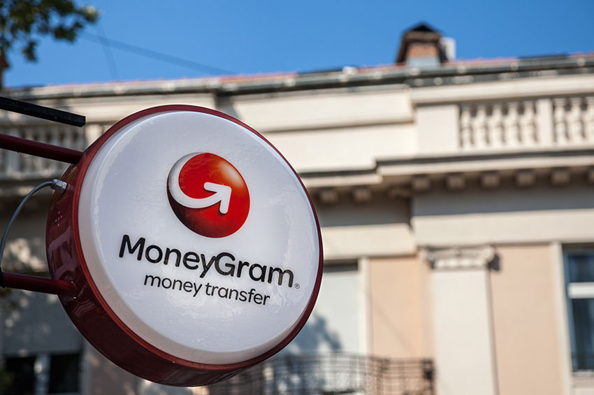 Moneygram money transfer display in front of a building.