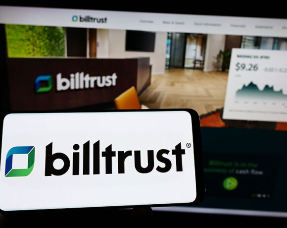 closeup shot of a smartphone with billtrust logo kept in front of a billtrust website.