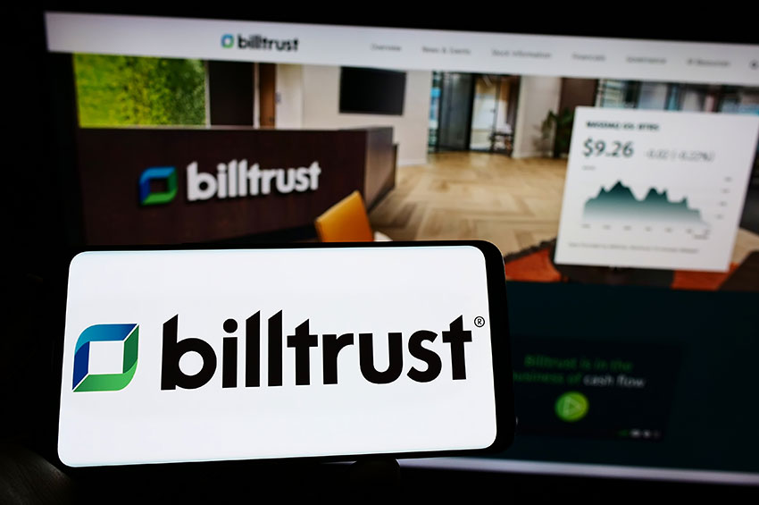 closeup shot of a smartphone with billtrust logo kept in front of a billtrust website.