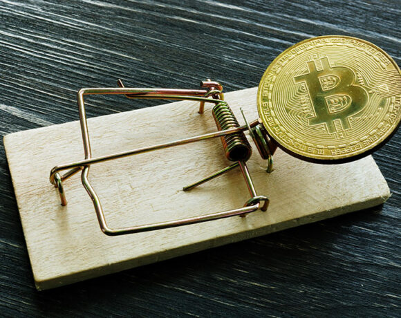 Mousetrap and bitcoin coin depicting bitcoin scam or fraud concept.