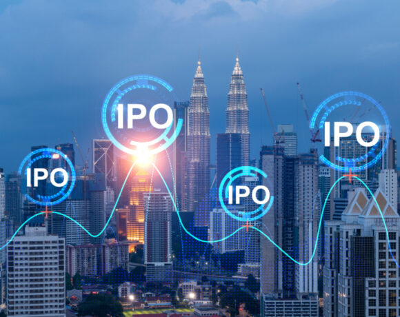 Initial public offering hologram over the night panoramic city view of Kuala Lumpur illustrates the concept of boosting growth by IPO process.