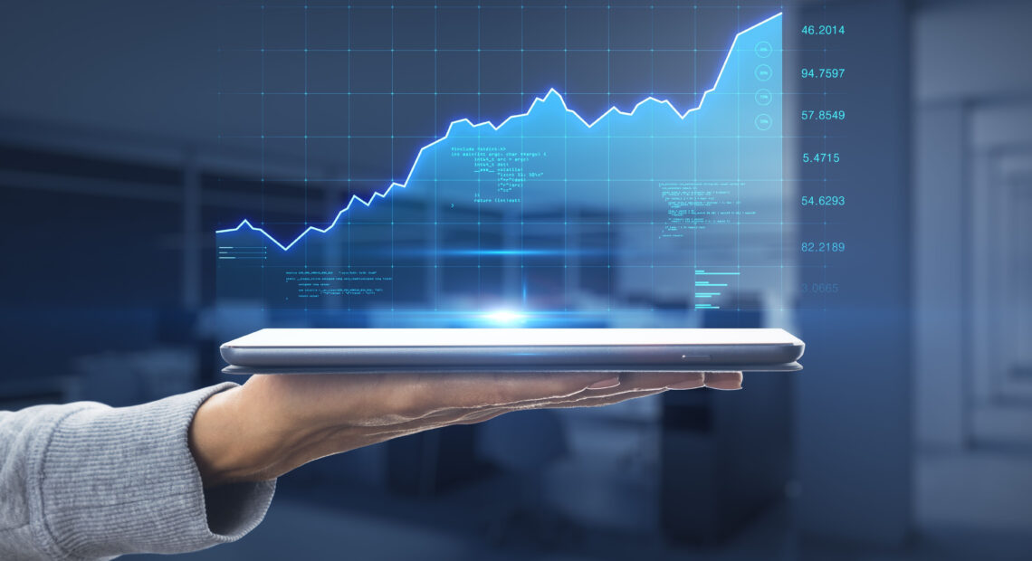 Fintech stock market growth concept with a digital graph showing financial growth and indicators projected on a digital tablet.