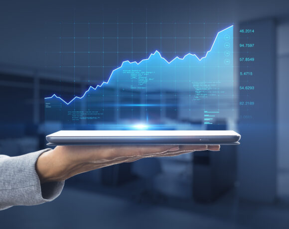Fintech stock market growth concept with a digital graph showing financial growth and indicators projected on a digital tablet.