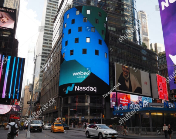 NASDAQ, National Association of Securities Dealers Automated Quotations, and Cisco Webex corporate logo sign near Times Square illustrate Nasdaq's delisting notice to Ozon Holdings.