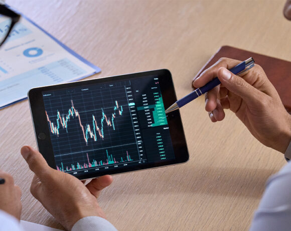 Square stock price prediction is illustrated by business investors discussing a trading chart using a digital tablet.
